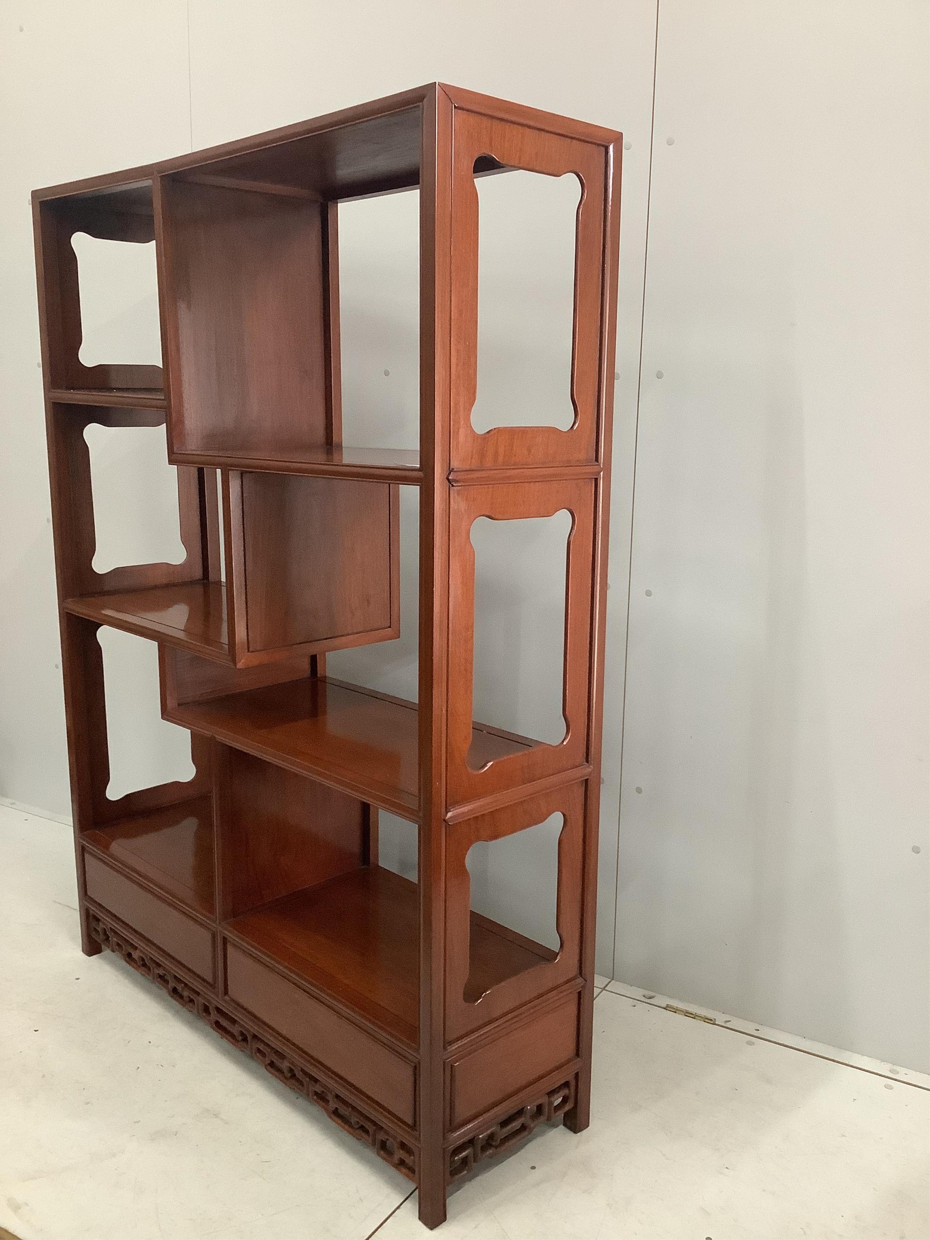 A Chinese padouk wood open shelves unit, width 132cm, depth 39cm, height 168cm. Condition - good